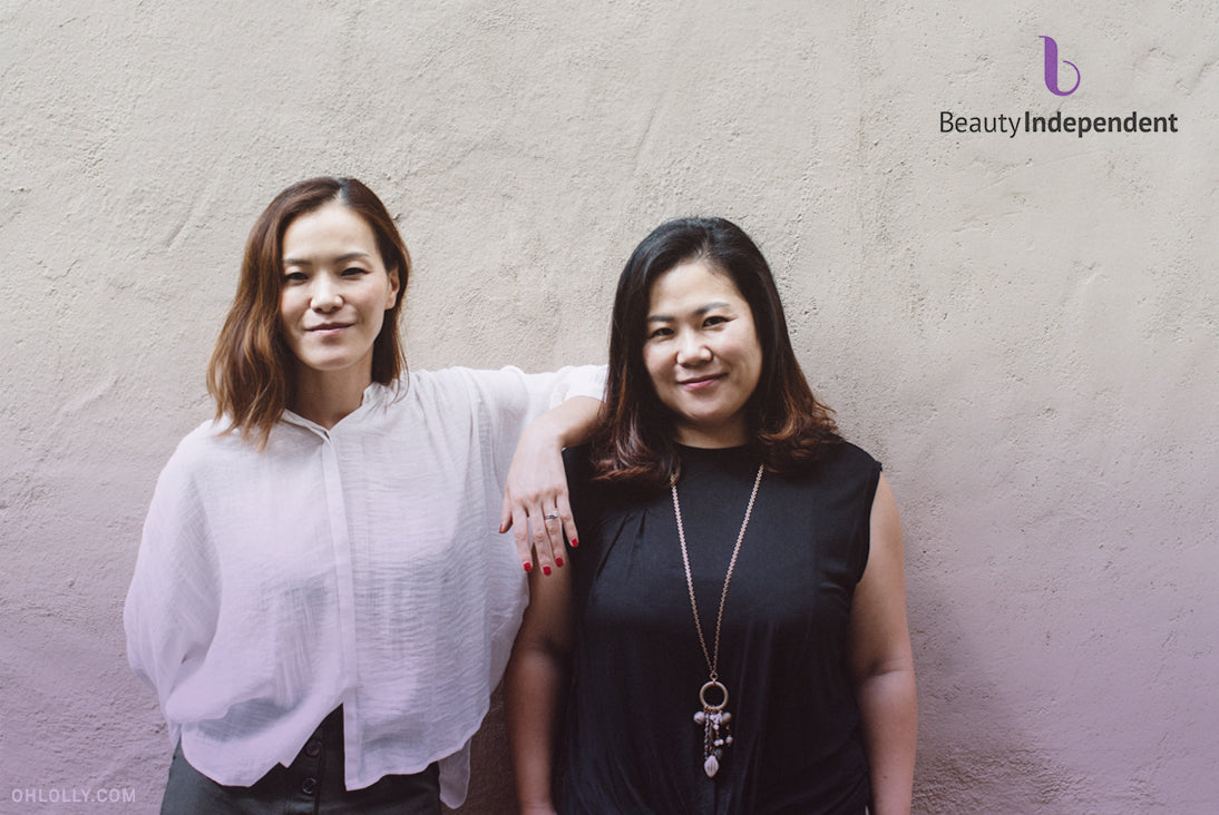 A photo of two women standing side-by-side with their arms around each other.