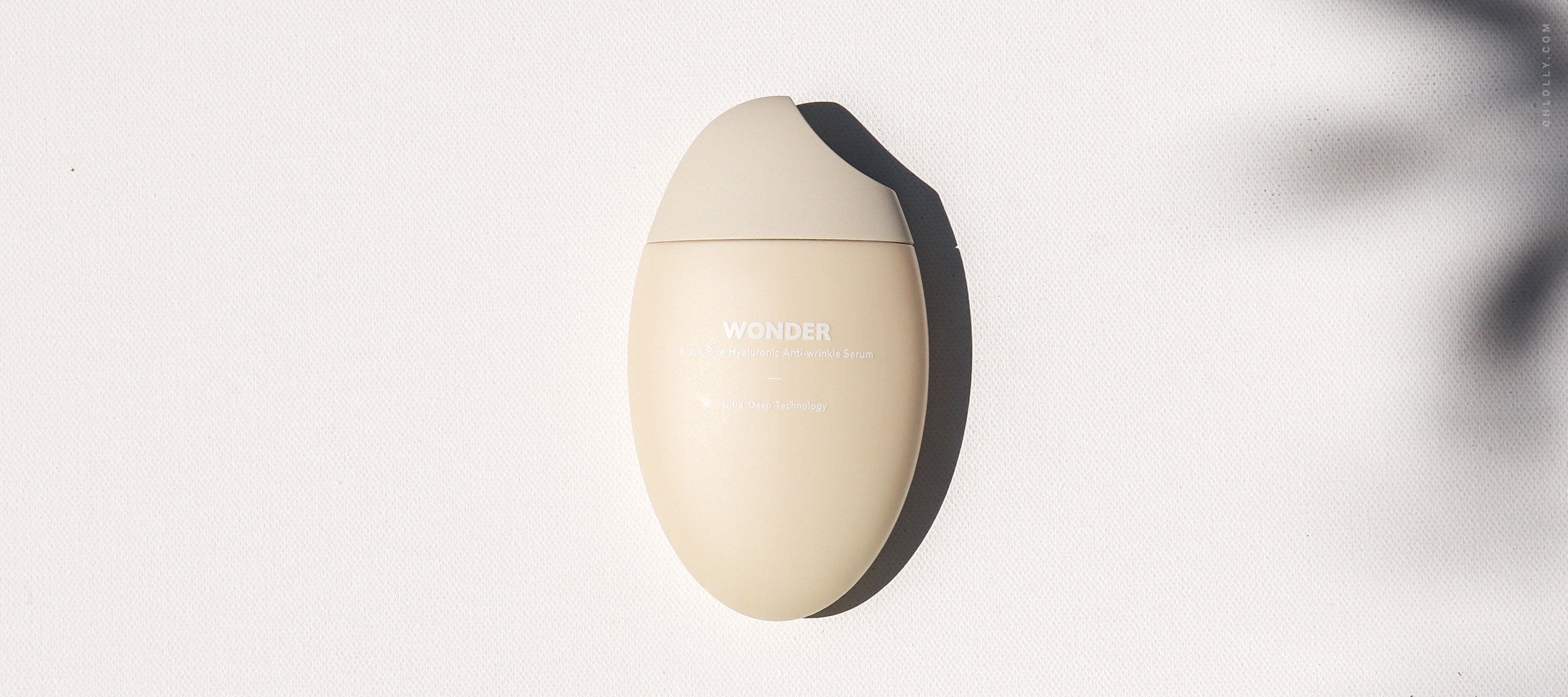 Single Haruharu Wonder Black Rice cream bottle, egg-shaped, resting on a white surface with shadows.