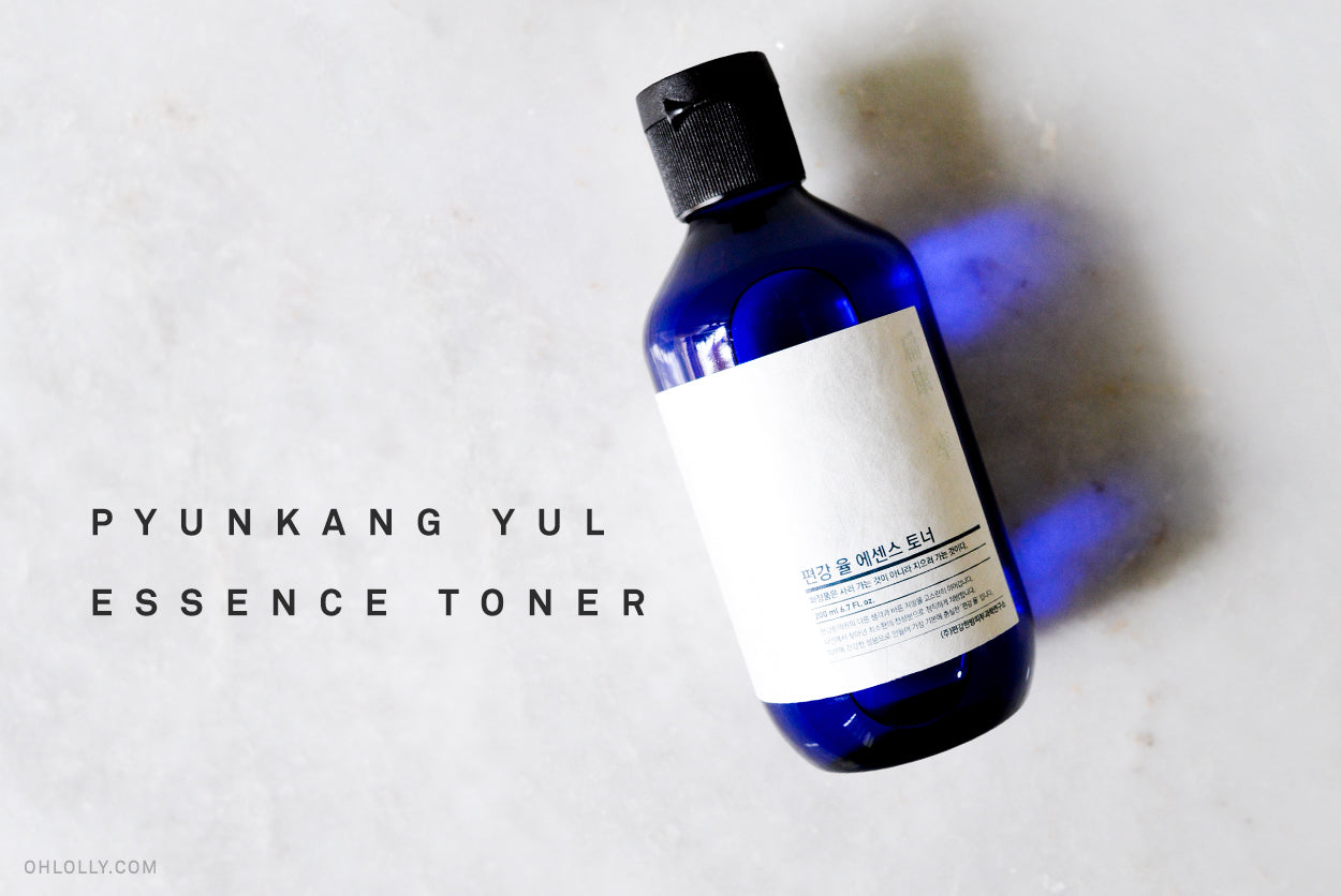 A blue bottle of skincare product with white labels and the text "PYUNKANG YUL ESSENCE TONER."
