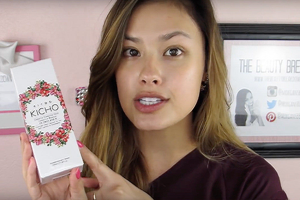 Beauty influencer holding up and talking about a Kicho skincare product with pink floral packaging.