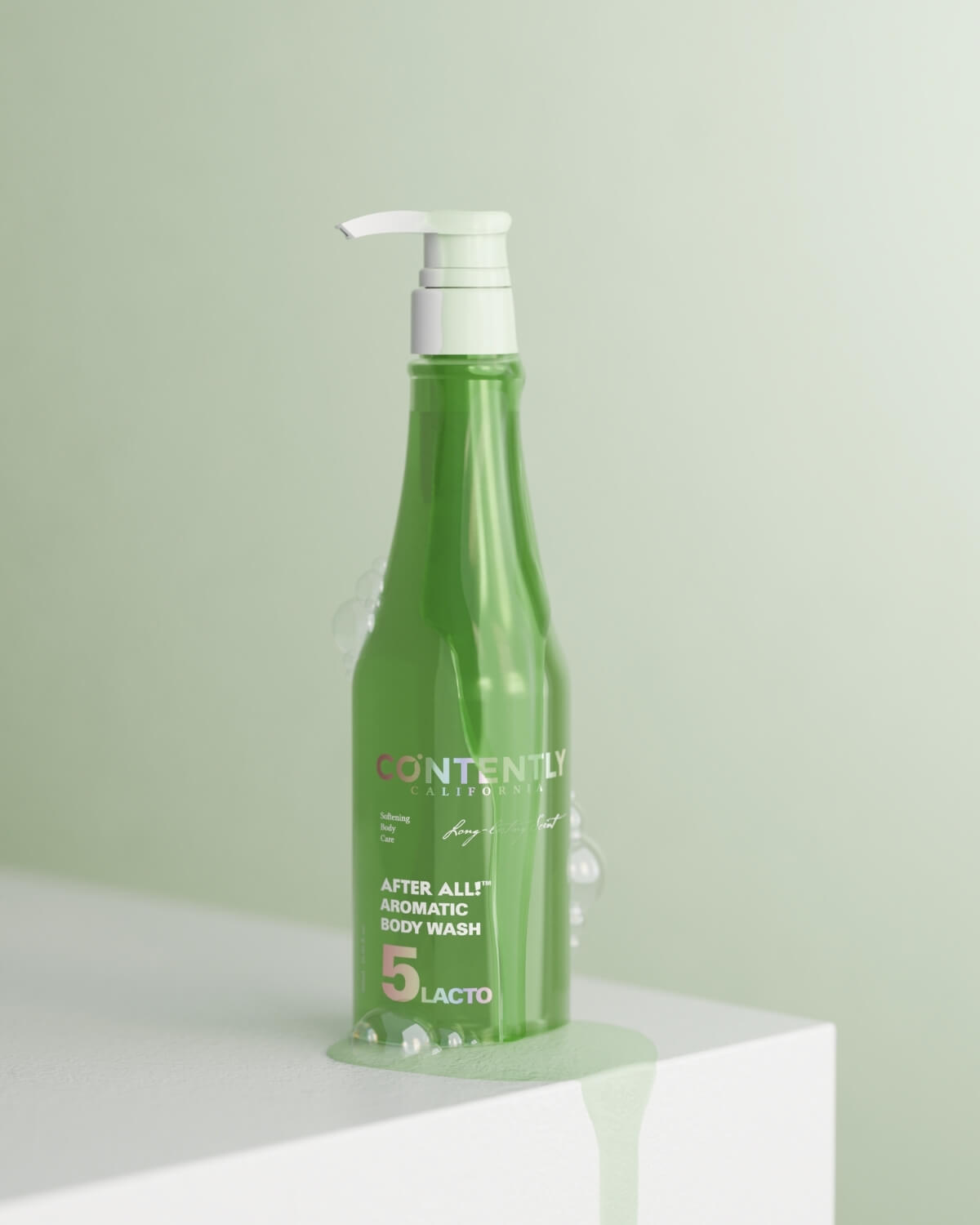 A green bottle of CONTENTLY CALIFORNIA's "After All! Aromatic Body Wash" with a white cap stands on a white cube. Clear green liquid is visible around the base and dripping off the side of the cube, with a few white bubbles near the bottle. The background is a soft green.