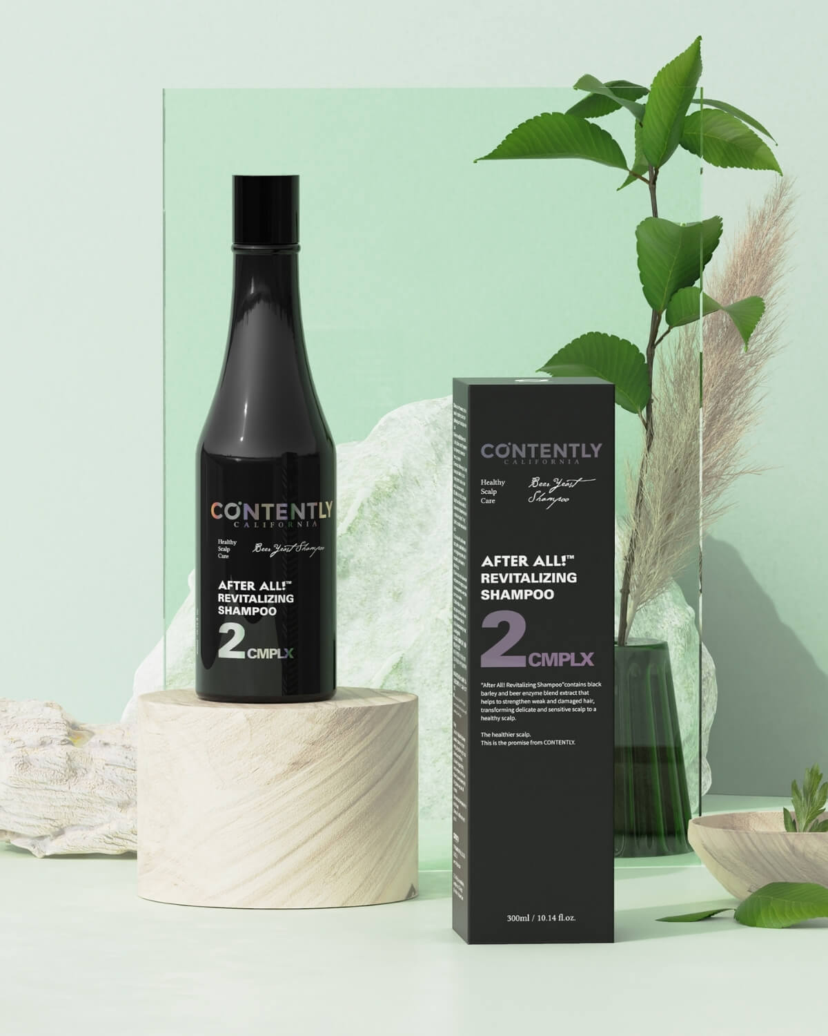 The shampoo bottle stands on a white cylindrical pedestal next to its black retail box in a natural setting with green foliage and a light green screen.