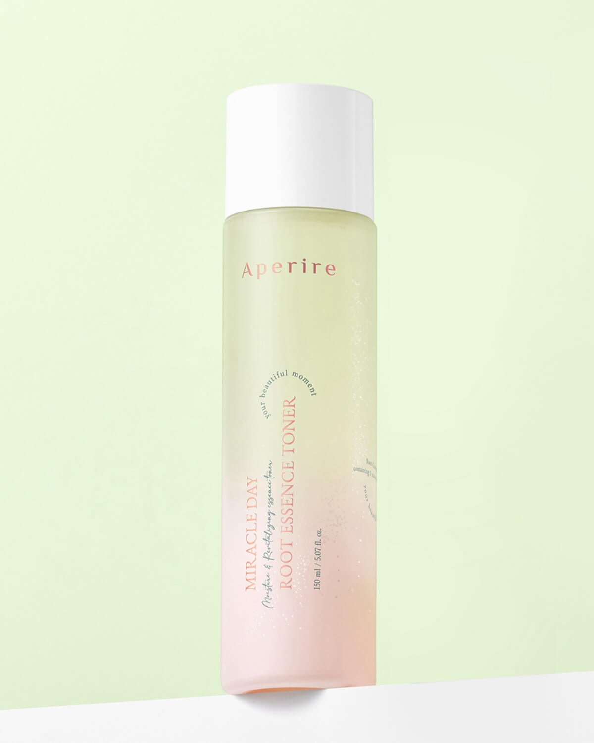 A clear, amber-colored drop of the toner is suspended just above the tip of the glass dropper, which is held over the bottle's opening.