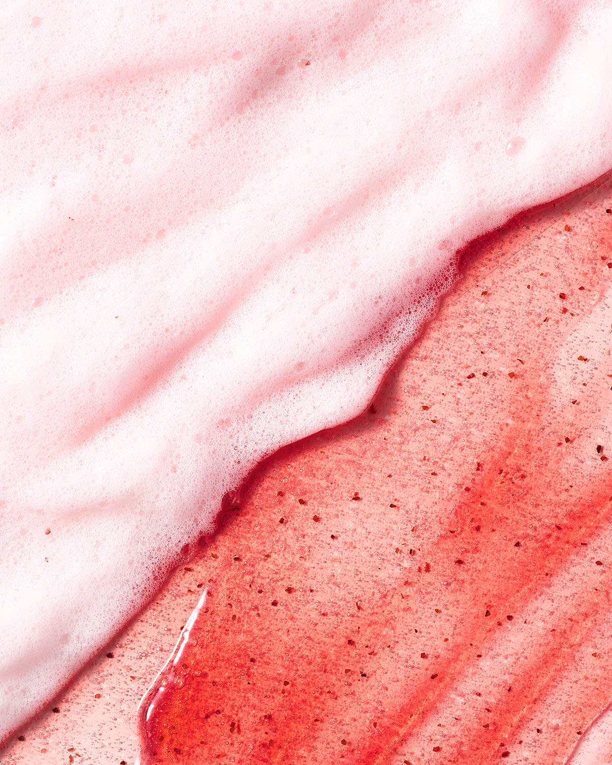 Close-up of rich red apple jam cleanser gel texture next to soft white soapy lather foam.