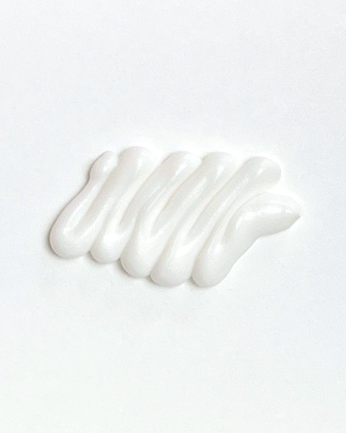 A dollop of white Bifi Blanche Foot Cream moisturizer showing the smooth texture.
