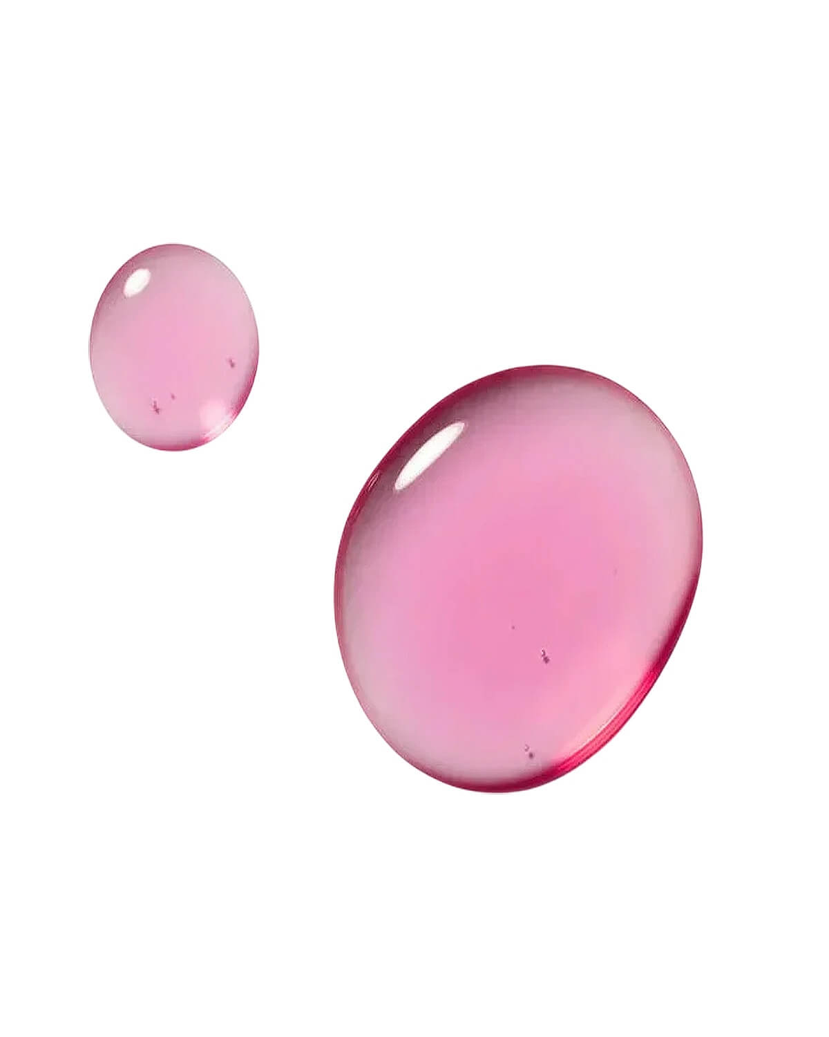 Two glossy drops of the Dexynol-16.3 Booster Essence's pink-hued serum on a clean white background, showcasing the product's color and liquid texture.