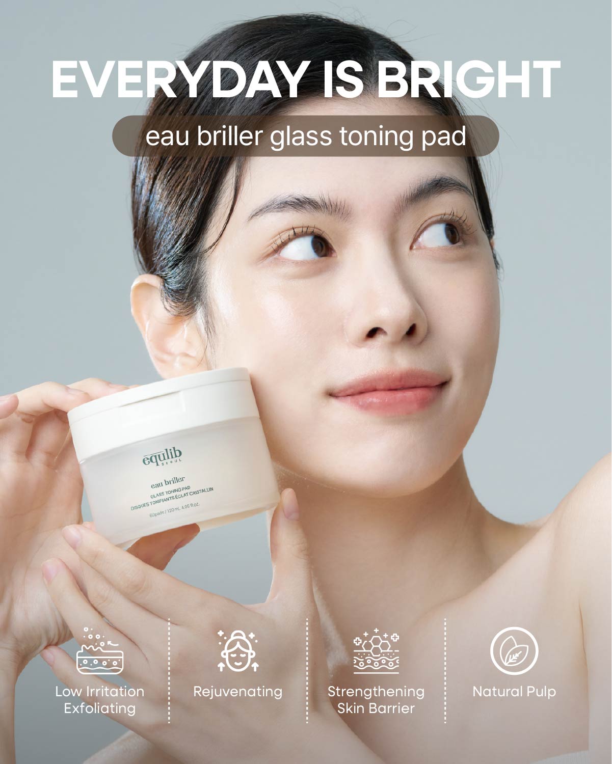 Smiling East Asian woman holding Equlib Glass Toning Pad tub for radiant, rejuvenated glass skin glow.
