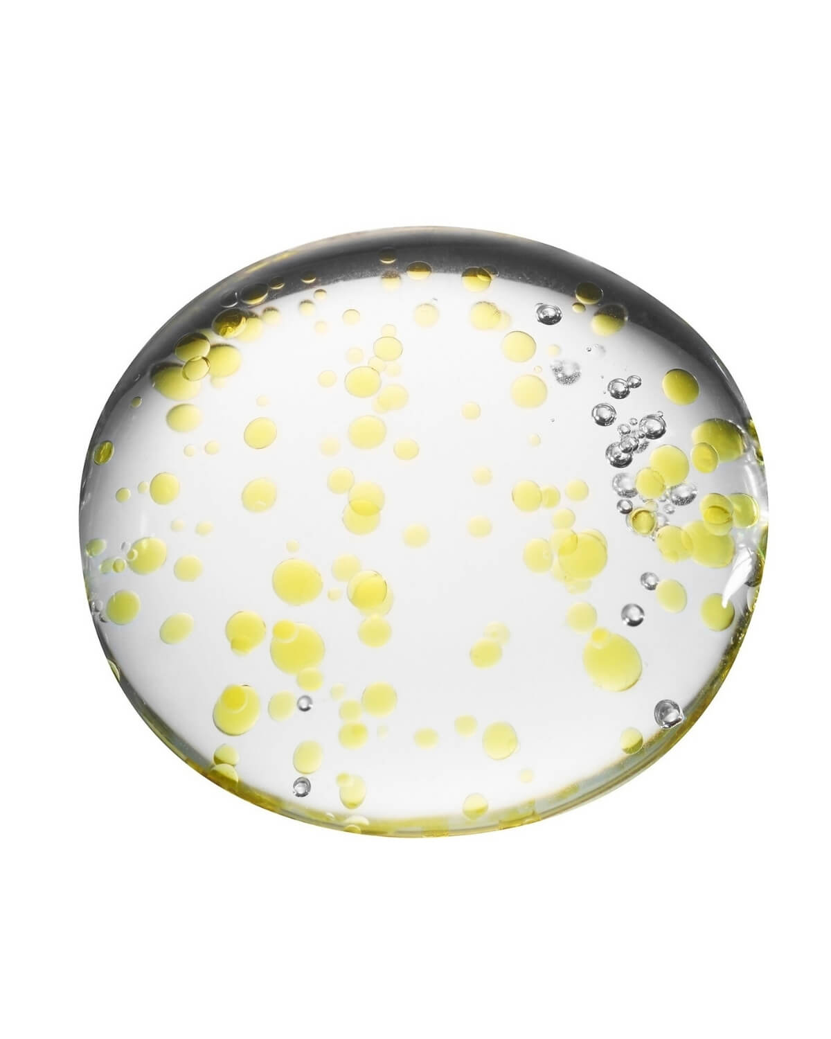 A close-up shot of the liquid contents of the ampoule, showing a clear, globular substance suspended with many small, bright yellow oil droplets and a few tiny air bubbles against a pure white background.
