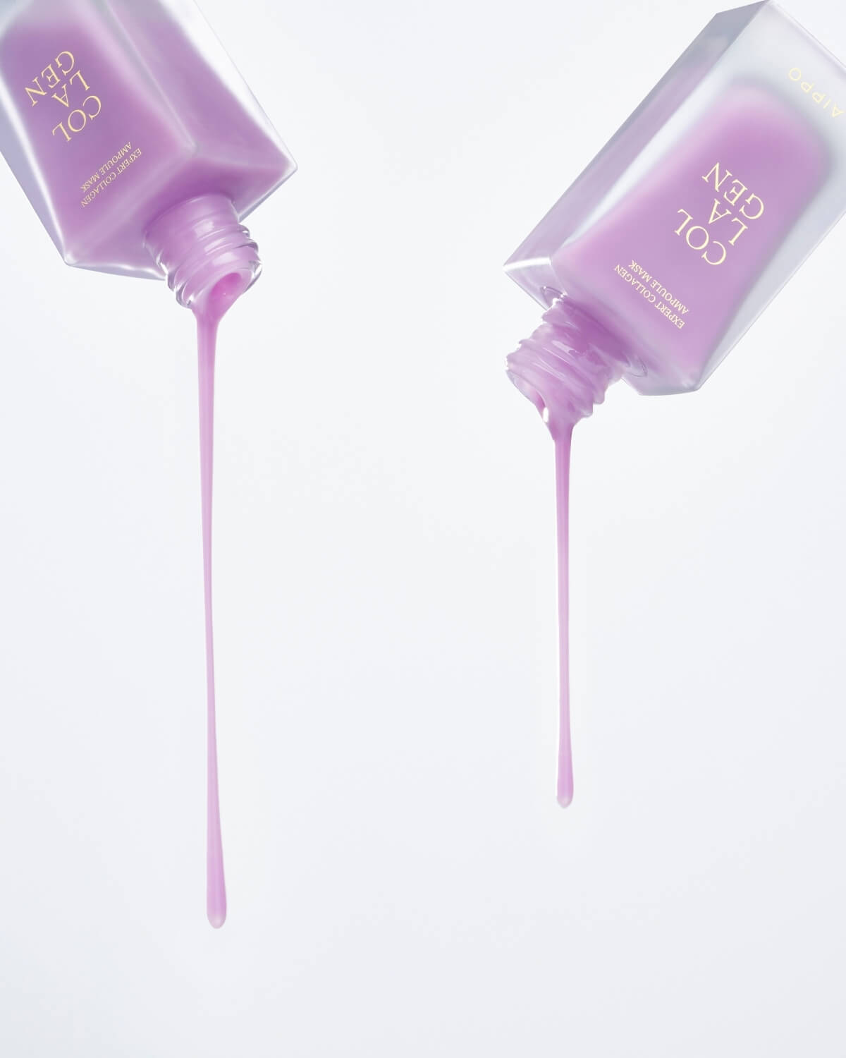 A dynamic shot of two square, frosted purple bottles of Aippo Collagen Ampoule Mask tilted upside down, with long, thick drips of the purple liquid ampoule stretching toward the bottom against a white background.