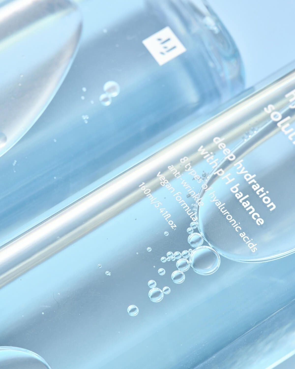 Close-up of the hydrating liquid texture and bubbles inside the Face Republic toner bottle.
