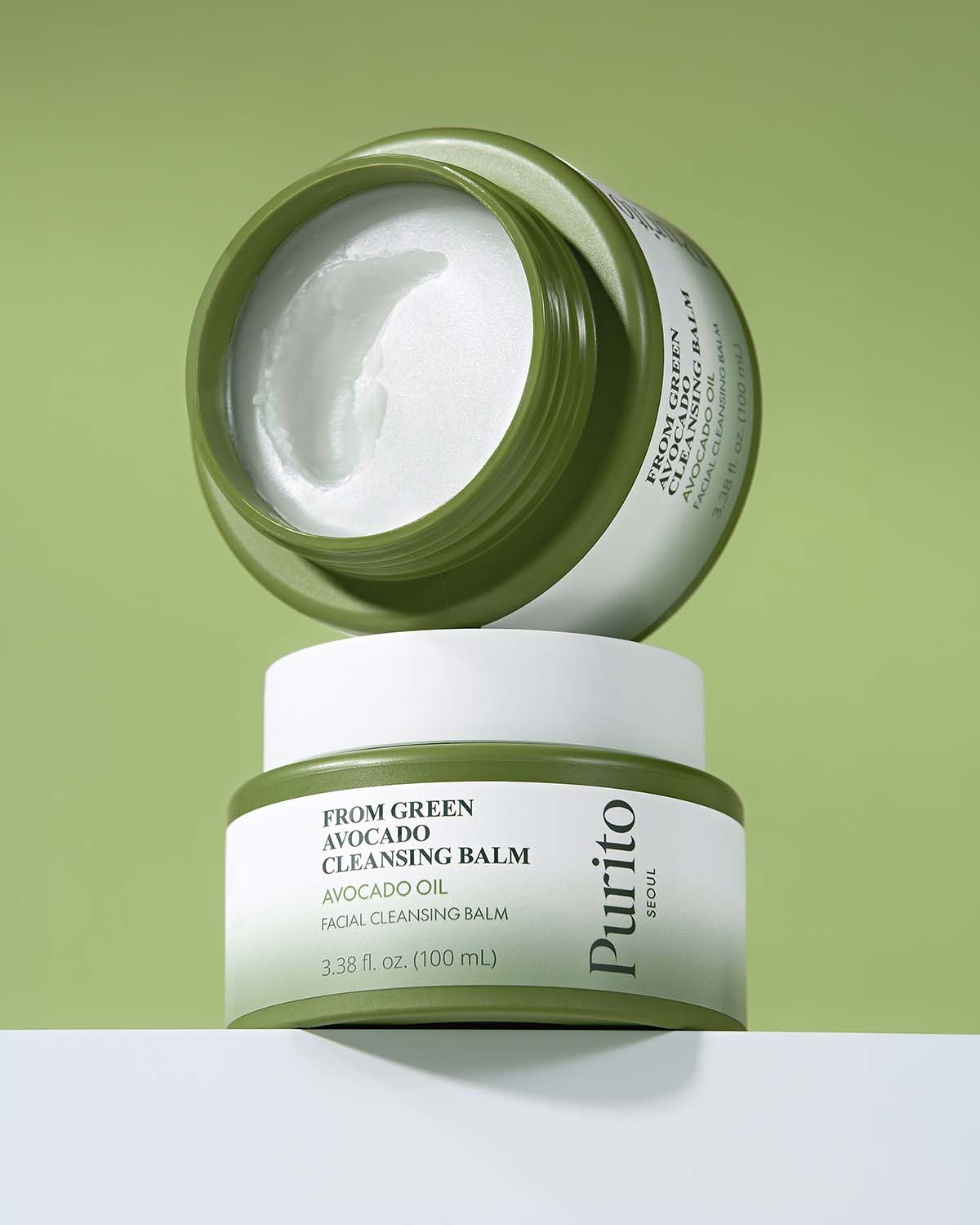 Two jars of Purito Avocado Cleansing Balm stacked vertically; the top jar is open to reveal the smooth texture.