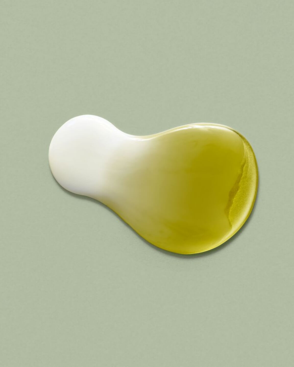 Texture shot of Jeju Matcha Tea Essence showing the milky white and green tea liquid phases blending together.