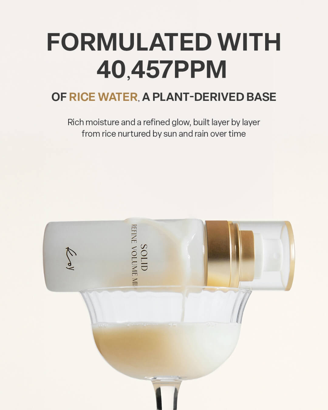 Koy Solid Refine Volume Mist formulated with rice water pouring into a cocktail glass for skincare hydration.