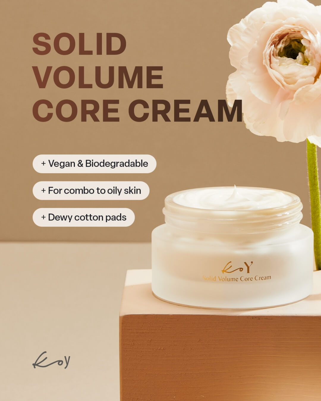 Open jar of Koy Solid Volume Core Cream next to a white flower displaying its rich vegan skincare formula.