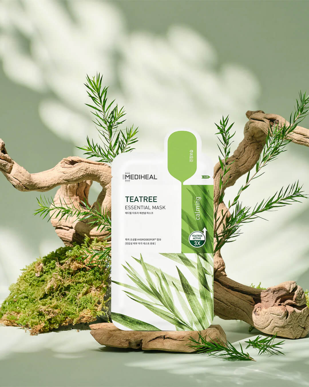 Mediheal Tea Tree Essential Mask_Intensive Calming & Clarifying Mask, product image on a green background