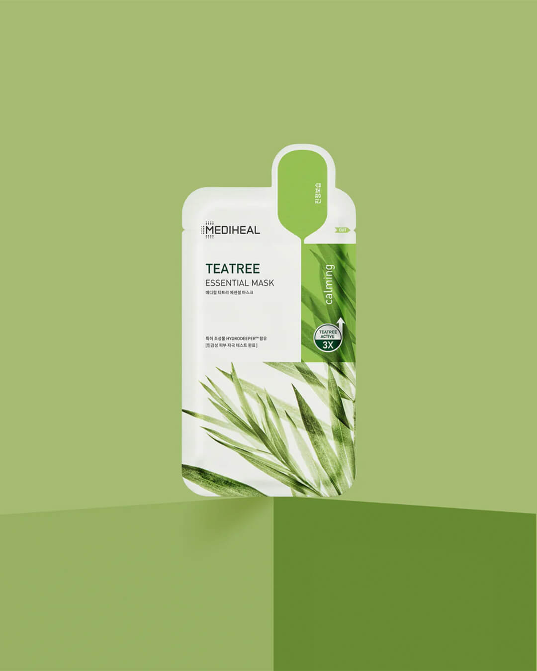 Mediheal Tea Tree Essential Mask_Intensive Calming & Clarifying Mask, product on a green background
