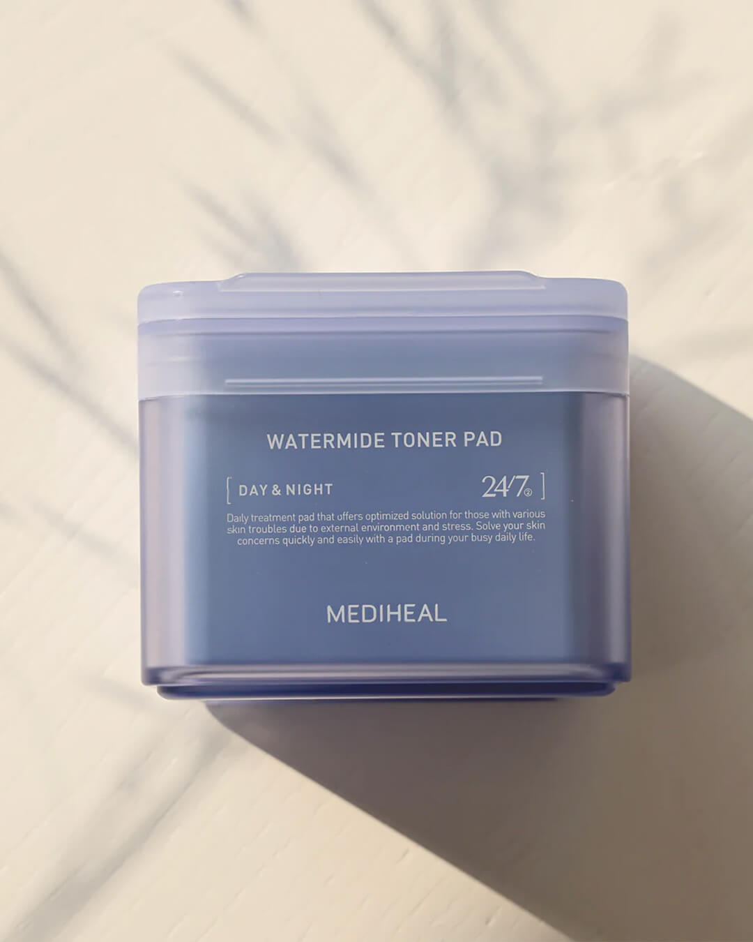 Mediheal Watermide Toner Pad_Hydrating & De-puffing Treatment Mask Pad, product on a cream background