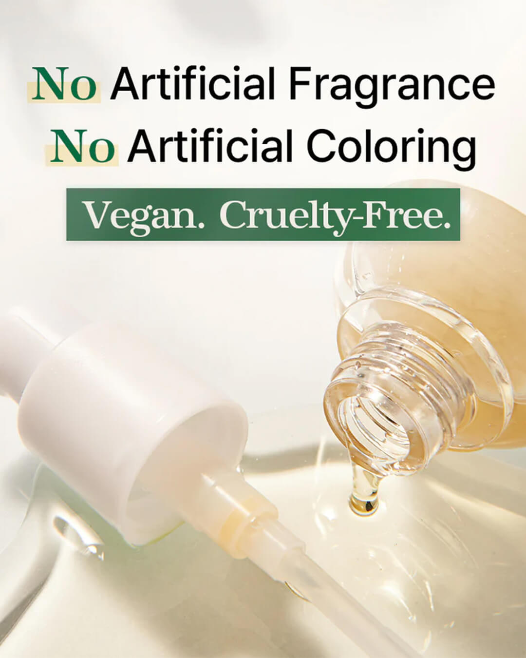 A close-up studio shot of the Mixsoon Bean Essence, showing the light yellow-gold essence dripping from the pump dispenser. The image is overlaid with text highlighting its clean claims: 'No Artificial Fragrance,' 'No Artificial Coloring,' and 'Vegan. Cruelty-Free.'
