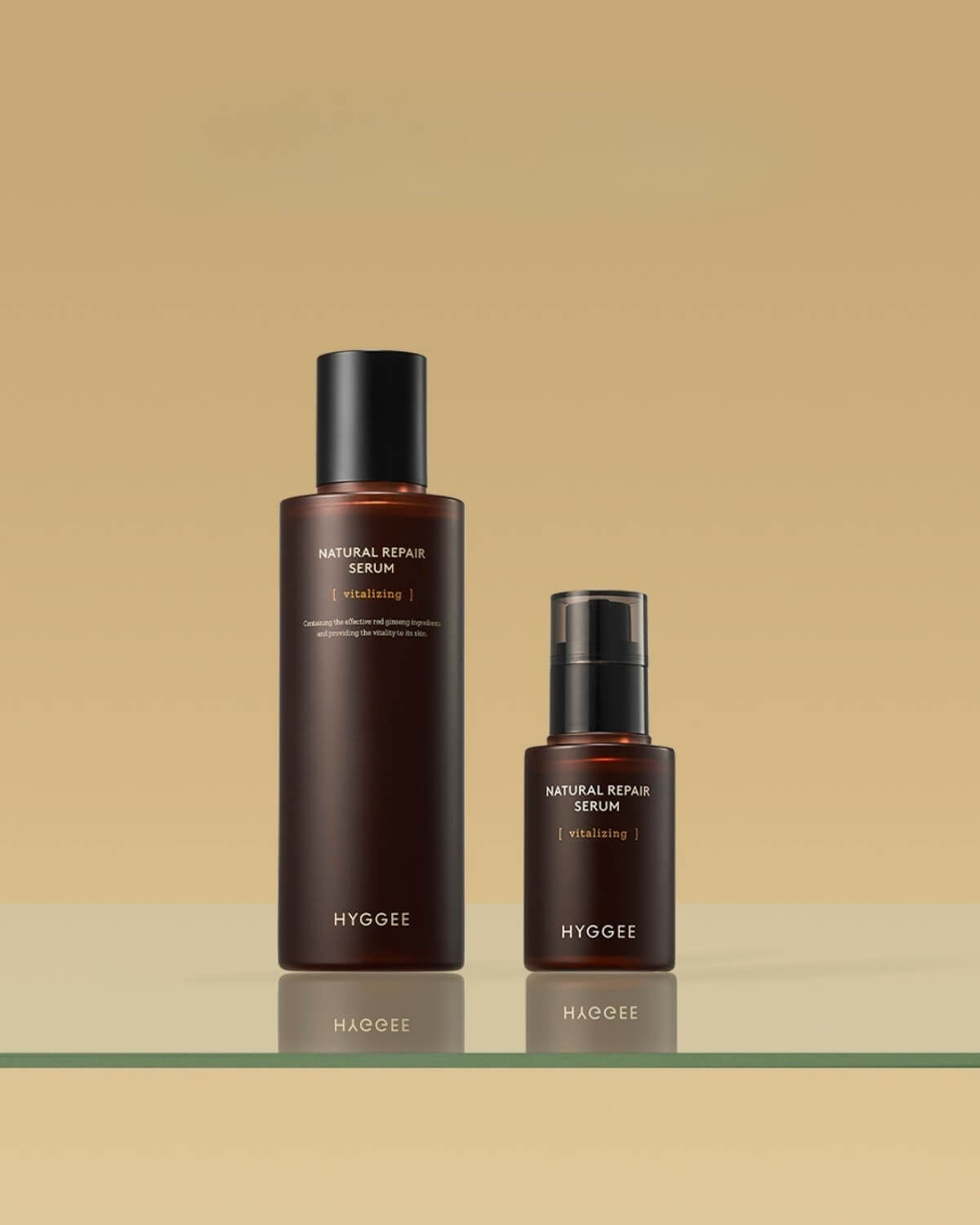 Two sizes of Hyggee Natural Repair Serum (Vitalizing) for promoting skin health, standing on a glass shelf.