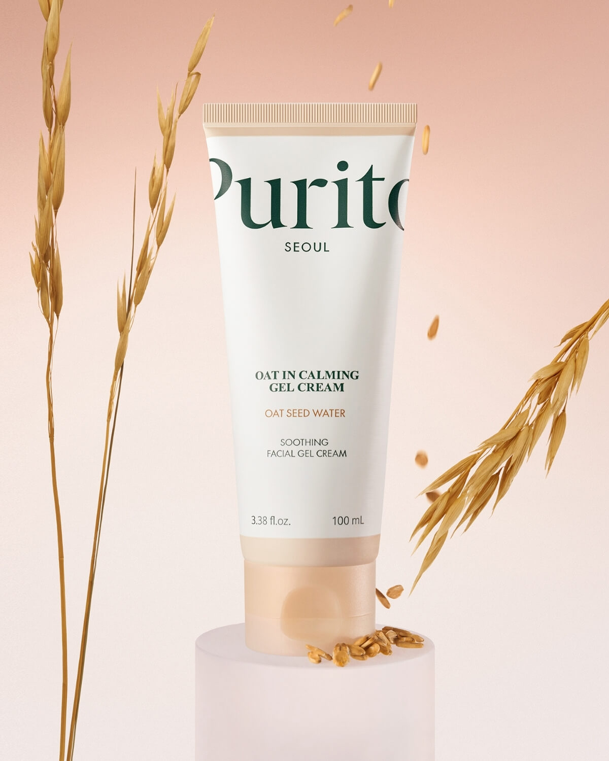 Purito Oat-in Calming Gel Cream tube standing on a pedestal surrounded by oat stalks and grains.