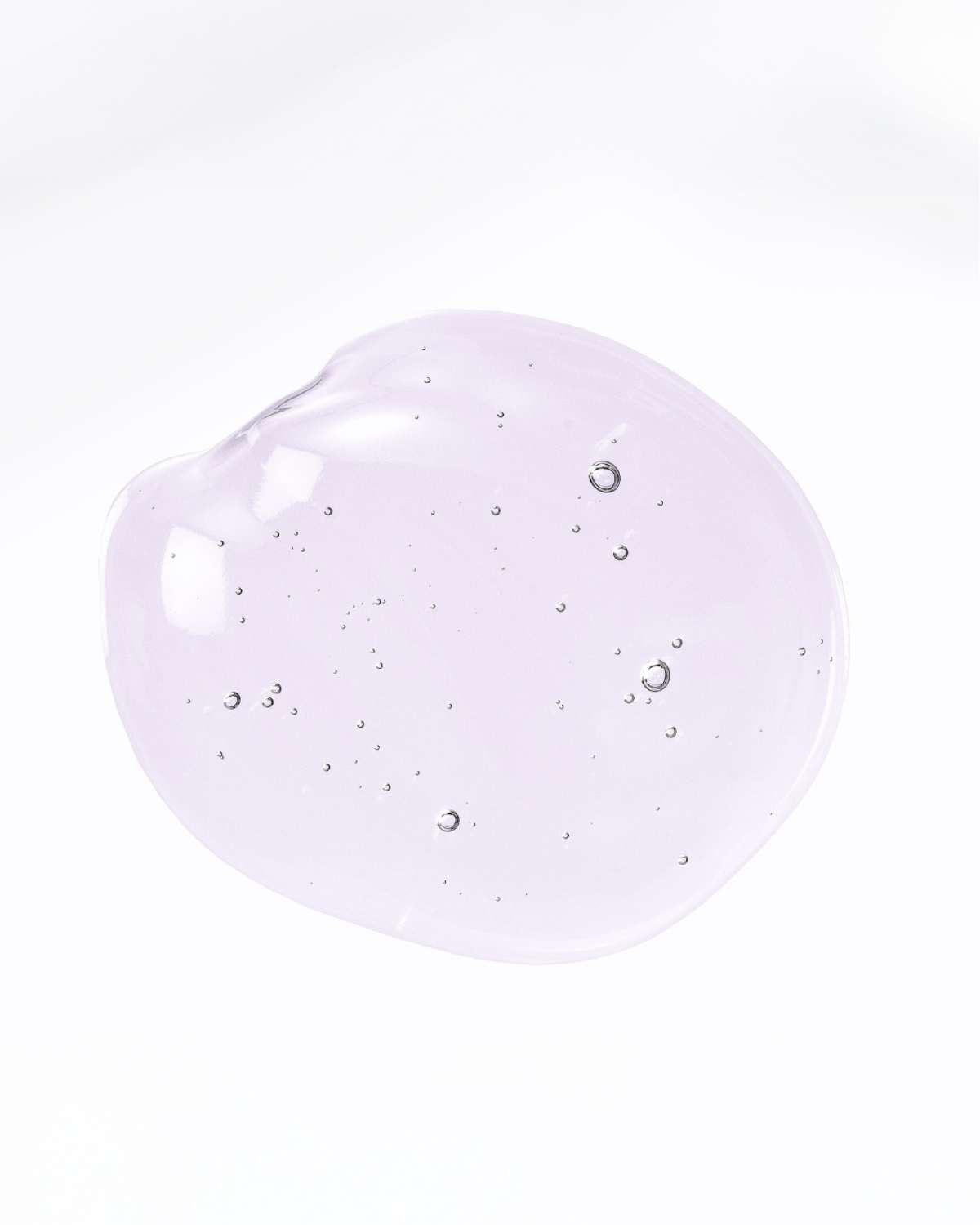 A smooth, translucent pink liquid swatch of the Teluris Glow Plump Serum on a white background.