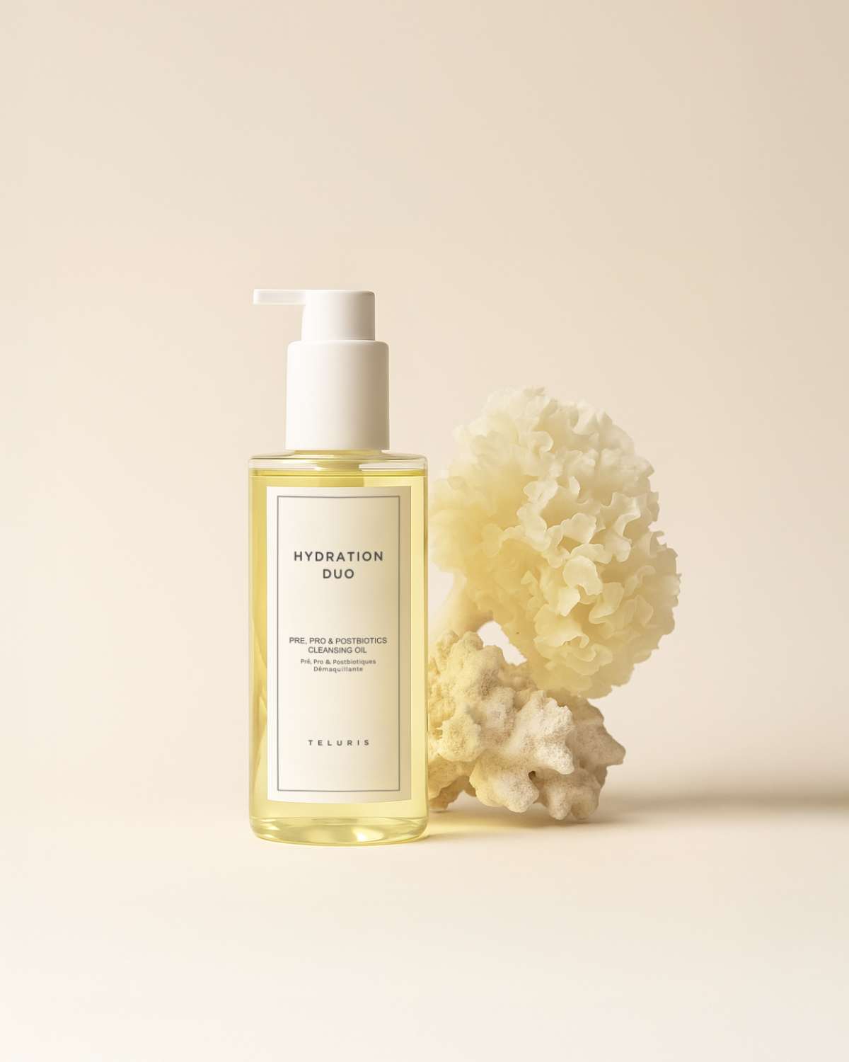 Teluris Cleansing Oil bottle styled on a natural wood branch for a minimalist, organic skincare look.