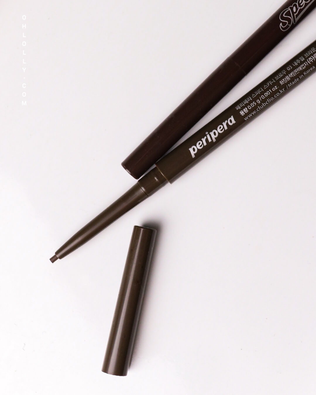 An angled close-up of the Peripera Speedy Skinny Brow pencil with the cap removed, focusing on the ultra-slim 1.5mm dark brown tip extended, emphasizing the precision and fine detail of the brow pencil.