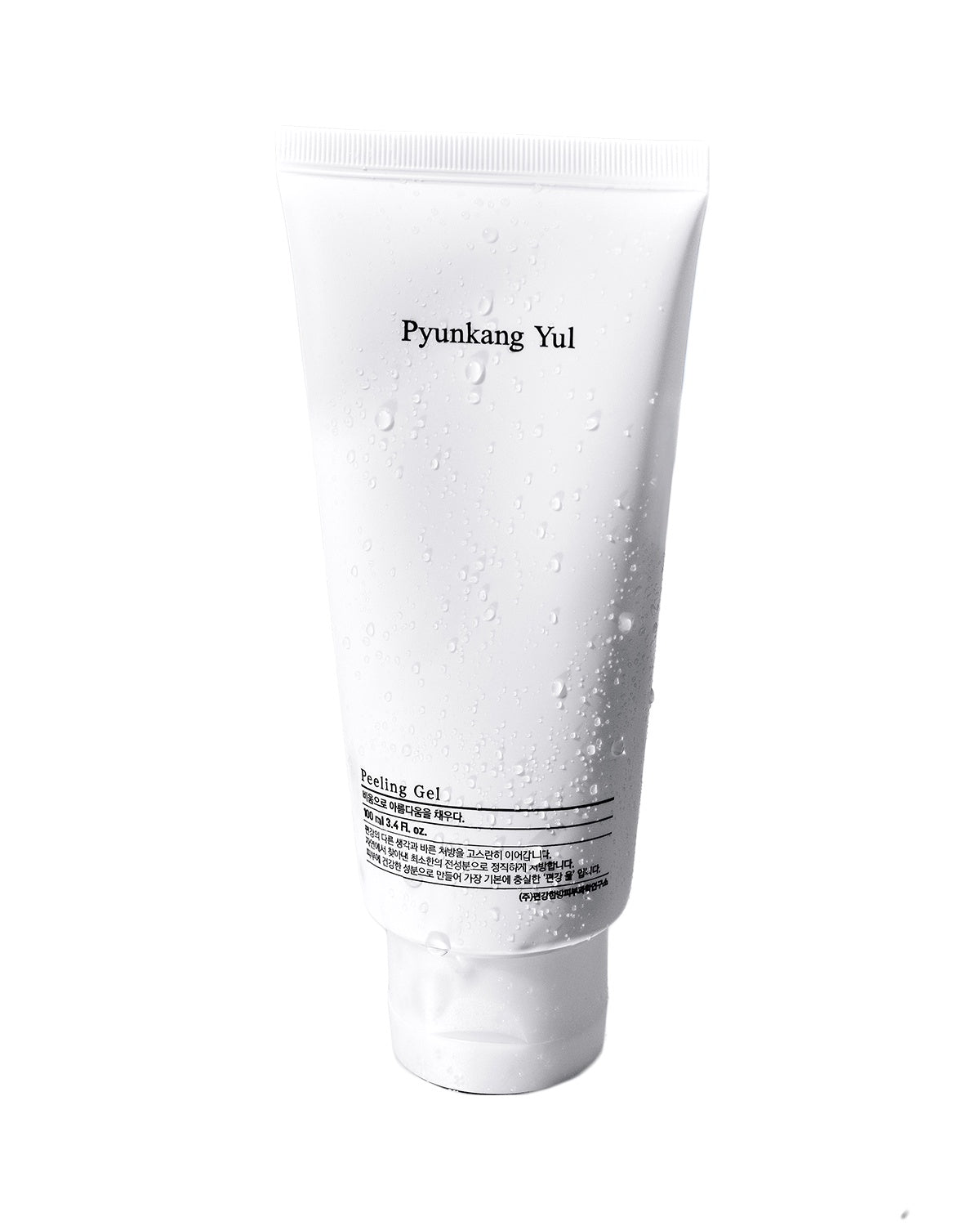 Studio shot of the Pyunkang Yul Peeling Gel tube covered in small water droplets, highlighting the product's refreshing, water-based formulation.