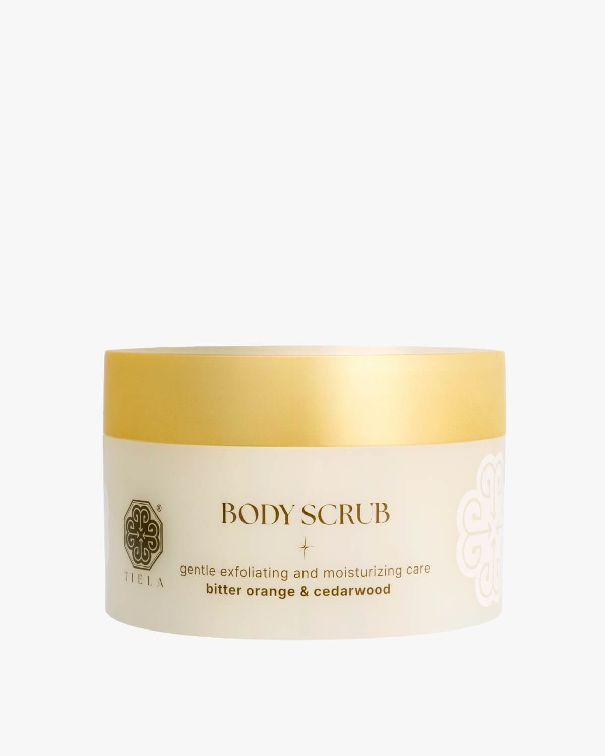 Front view of a round Tiela Body Scrub jar in a neutral beige with a bright yellow gold lid, labeled "gentle exfoliating and moisturizing care bitter orange & cedarwood."