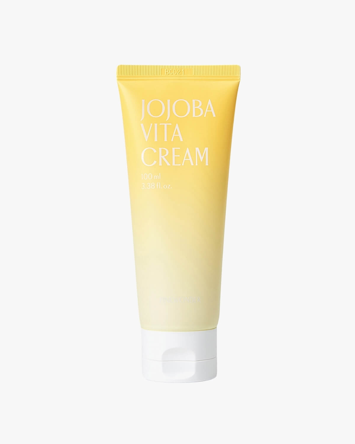 A straightforward studio product shot of the Pinkwonder Jojoba Vita Cream tube on a white background. The tube is a bright yellow that fades to a pale yellow-white near the bottom, with a white flip-cap.
