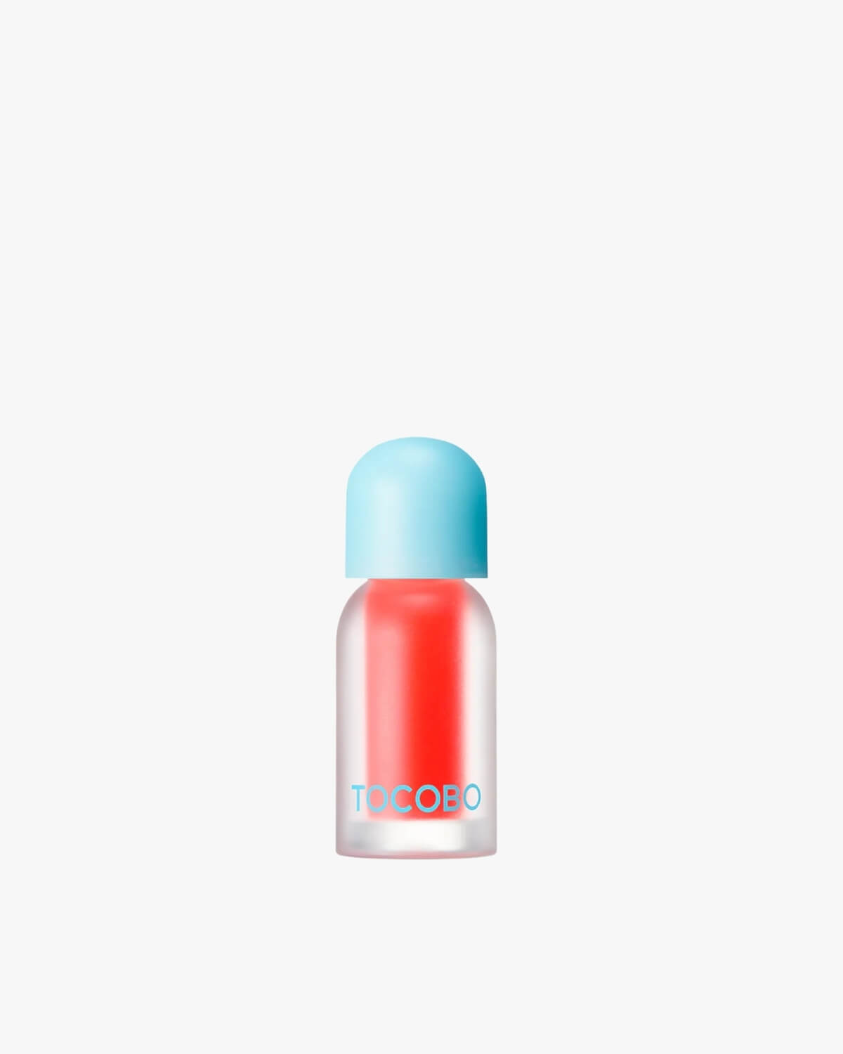 A bottle of Tocobo Juicy Berry Plumping Lip Oil in the bright orange-pink shade 15 Coral Soda.