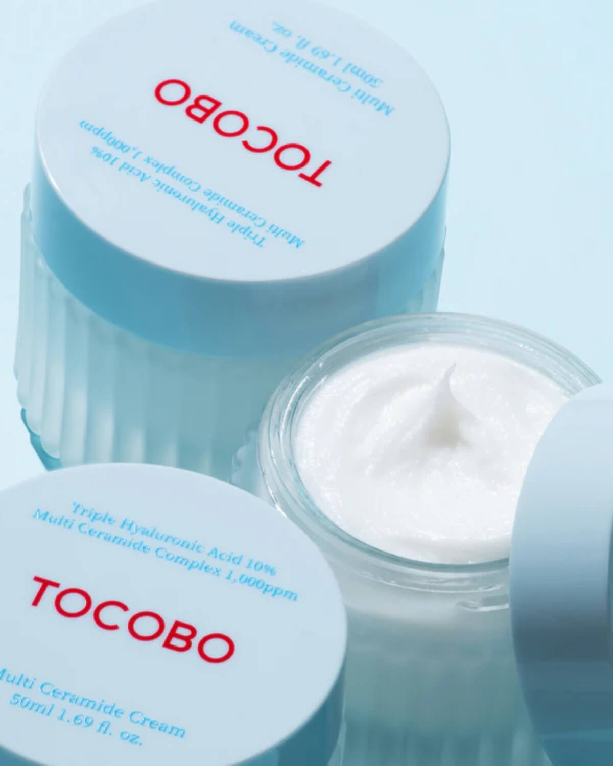 Open jar of Tocobo Multi Ceramide Cream showing the rich, thick white cream texture and blue lid.