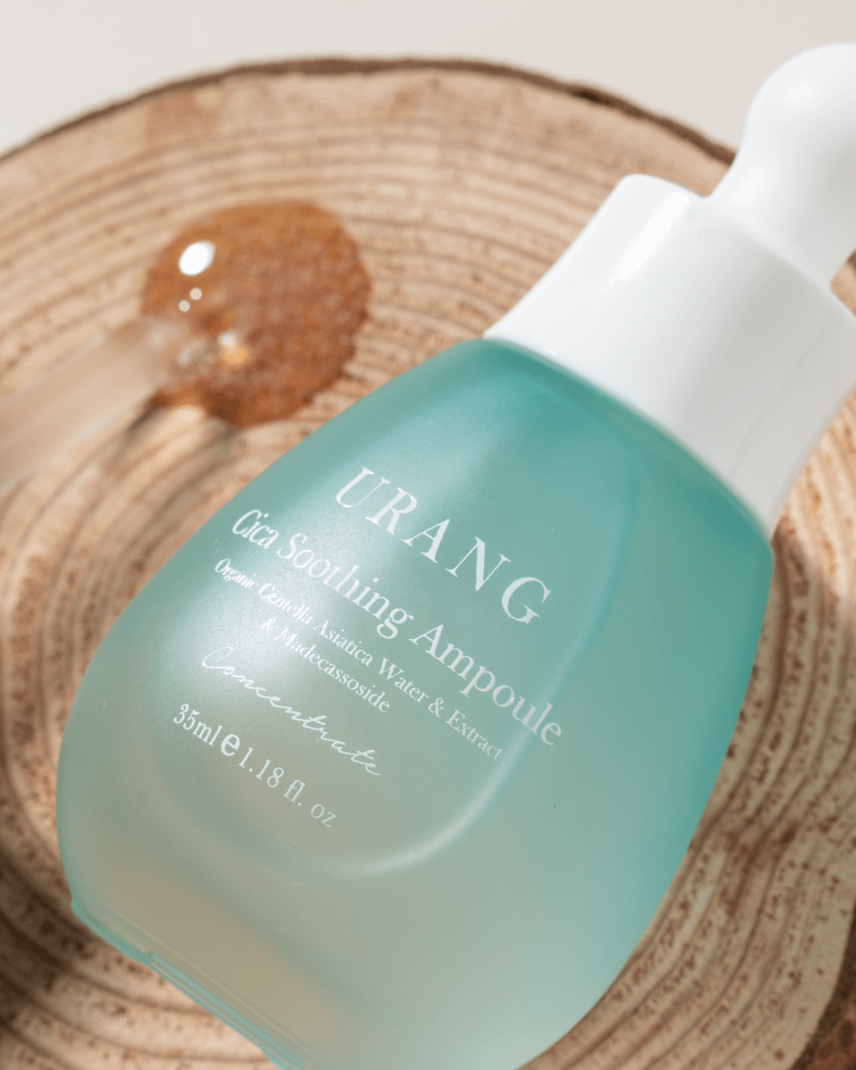 Extreme close-up of the Urang Cica Soothing Ampoule label, highlighting the organic Centella Asiatica leaf water and extract that repairs and soothes delicate skin.