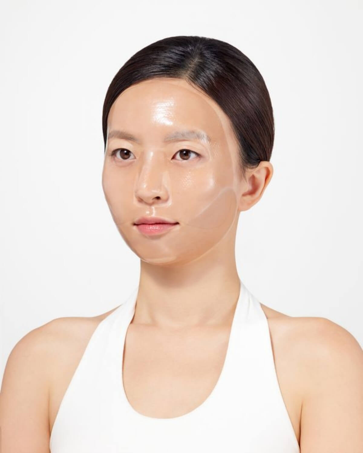 Close-up of the transparent hydrogel mask on skin, showing the high-adhesion "second skin" fit for maximum essence absorption.