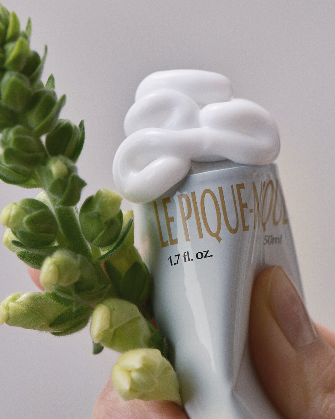 Ohlolly Korean Skincare Vinoir Decanting Hand Cream | Le Pique-Nique. Scented moisturizer for dry hands. Texture squeezed out of tube. Flowers. Closeup.