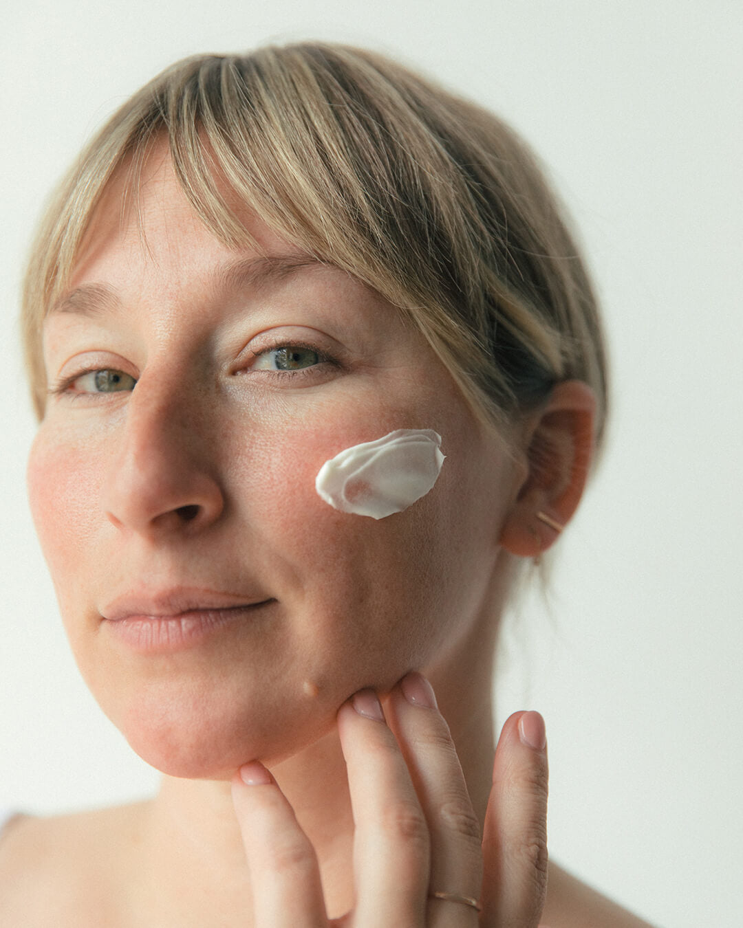 WYLYS Nightinol Cream Texture on Model When You Love Your Skin 2% Triple retinol complex overnight renewing cream, texture on model face, Made in France, Luxury vegan cream