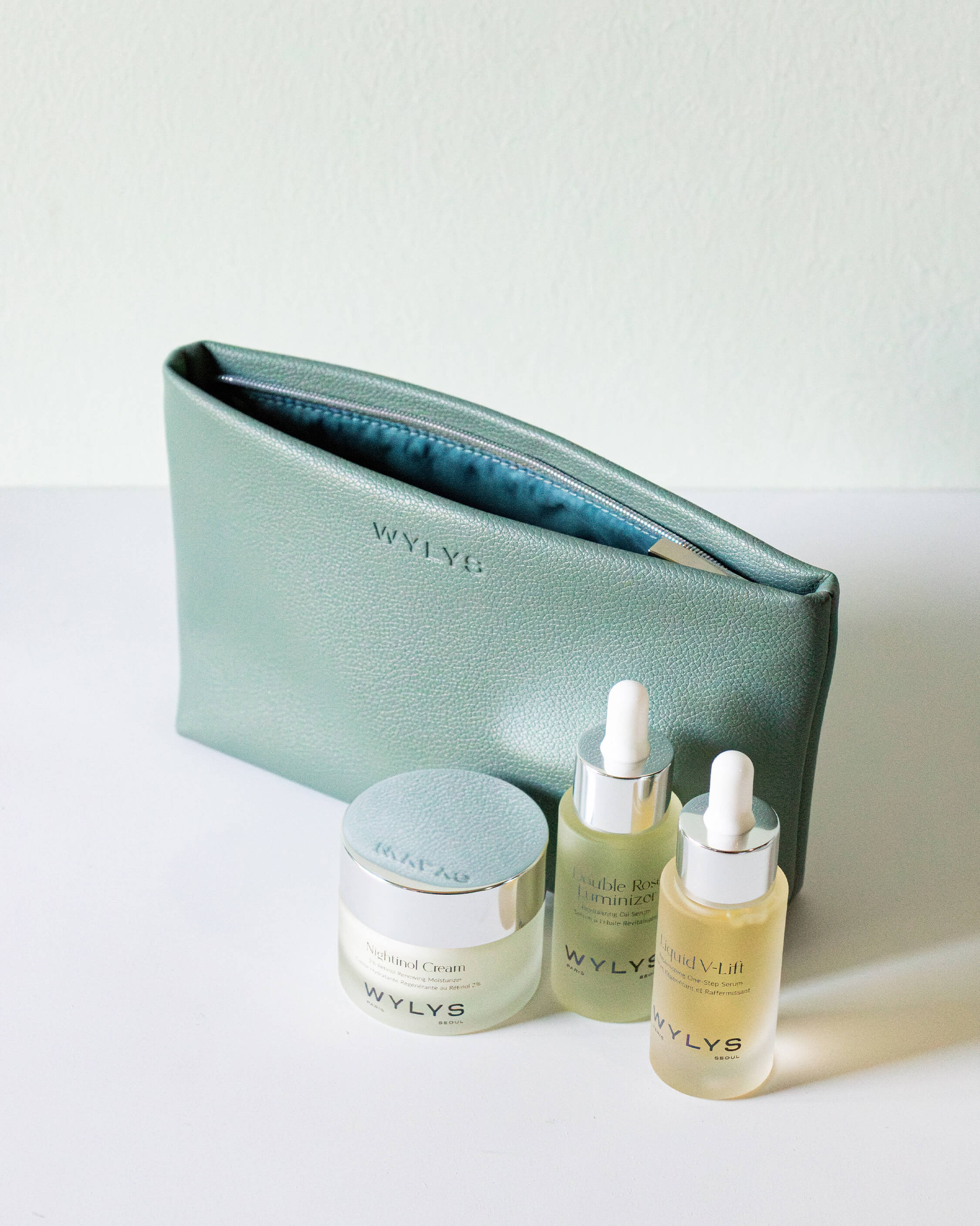 Wylys Sage Verte Makeup Bag – Soft Vegan Leather Pouch for Skincare & Makeup, Metal Zipper & water-resistant fabric Lining. Skincare in front of bag.