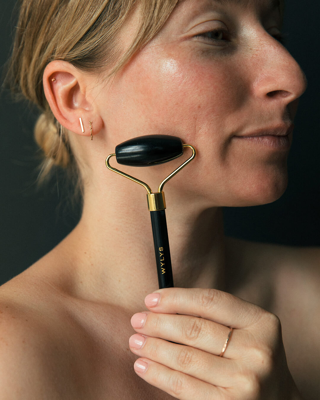 Ohlolly Korean Skincare Online Shop Wylys Black Obsidian Gua Sha + Face Roller Set, 100% natural Sculpting and depuffing tools for facial massage, tension relief, and radiant skin. Face roller on Model's face. Demo.