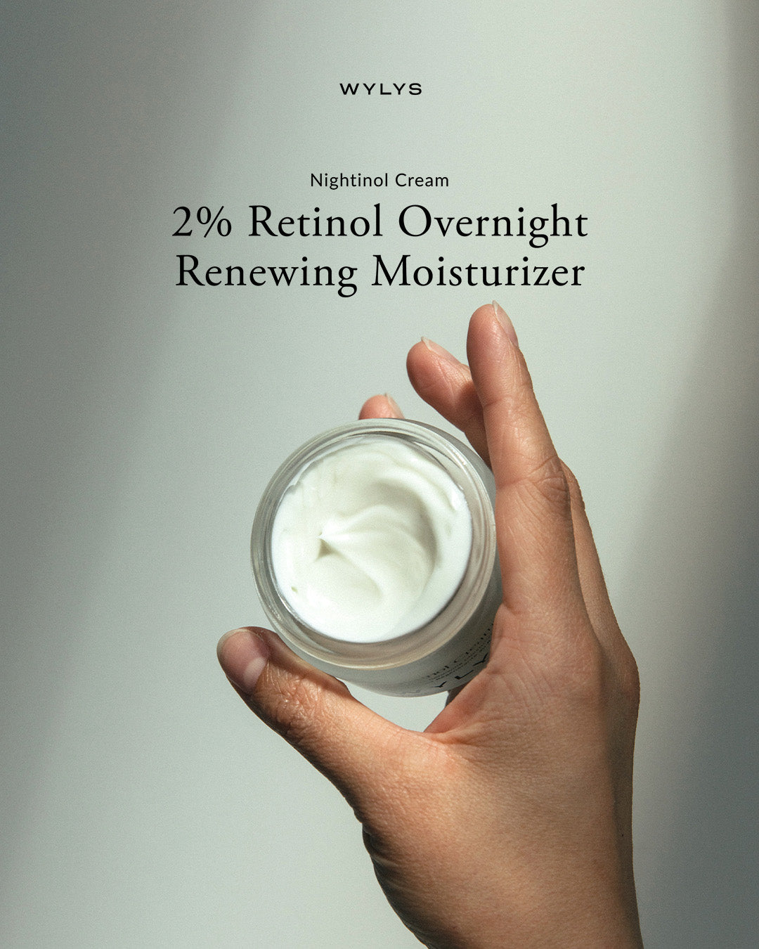 WYLYS Nightinol Cream 2% Triple Retinol Night Repair Cream Rich Cream for Anti-aging, Redness reduction, Plump, Brighter Skin. Algae peptides and ceramides to smooth wrinkles, firm skin, and boost radiance. Open jar in hand. Made in France