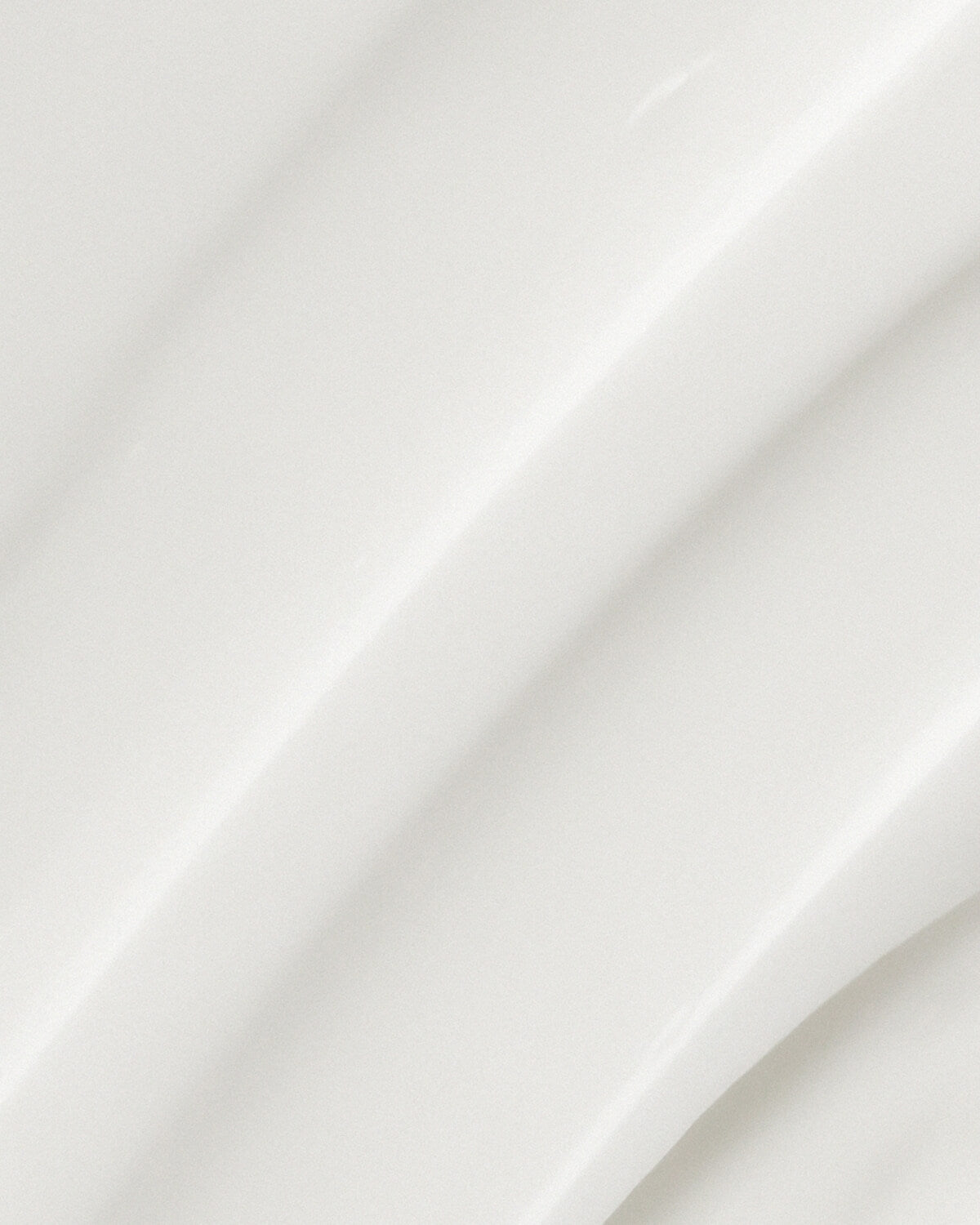 A high-resolution texture shot of the thick, glossy, white XCESPI 316™ Repair Cream, showing smooth ridges and curves.