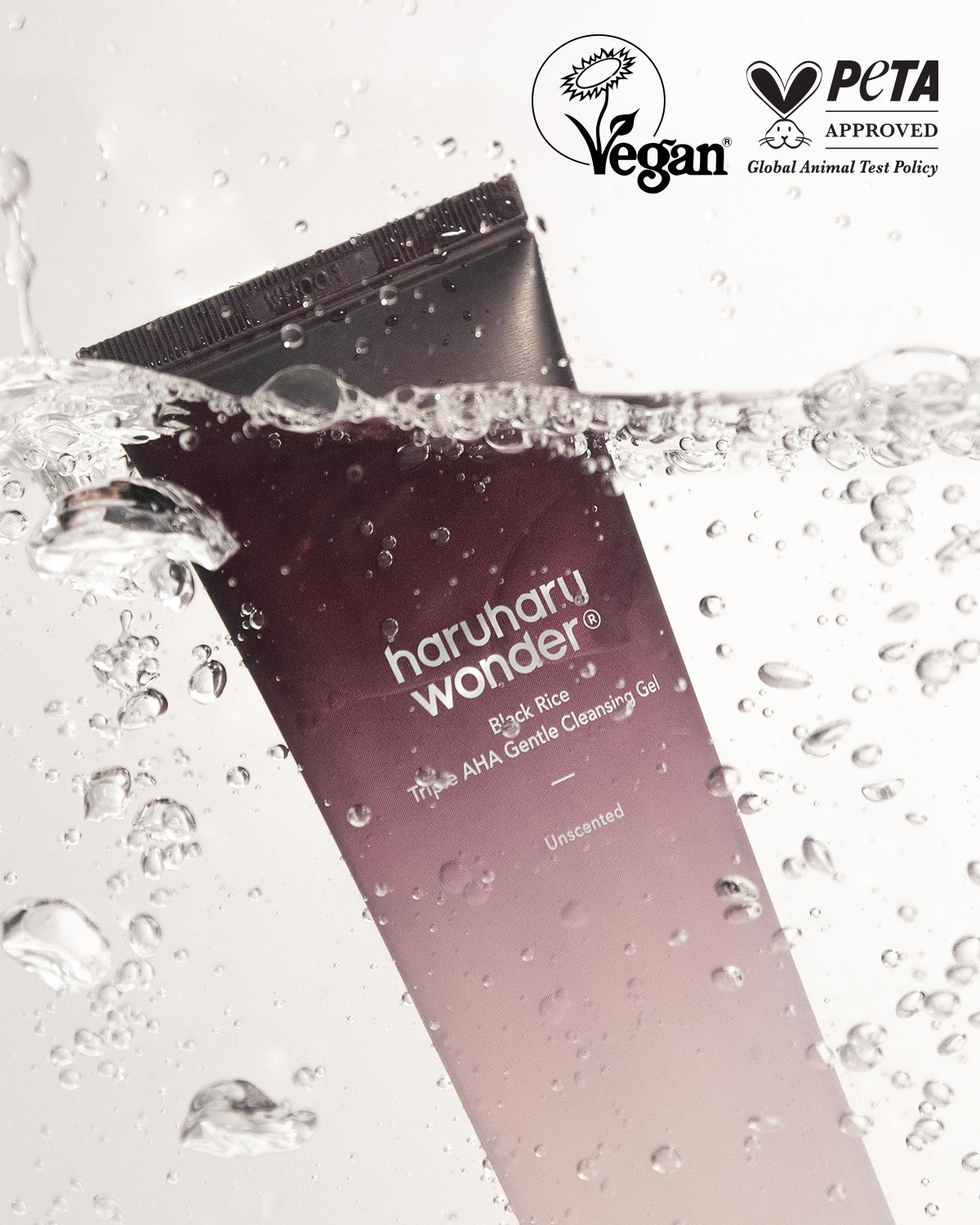 Vegan PETA-approved Haruharu Wonder Black Rice Triple AHA Gentle Cleansing Gel submerged in water. Unscented
