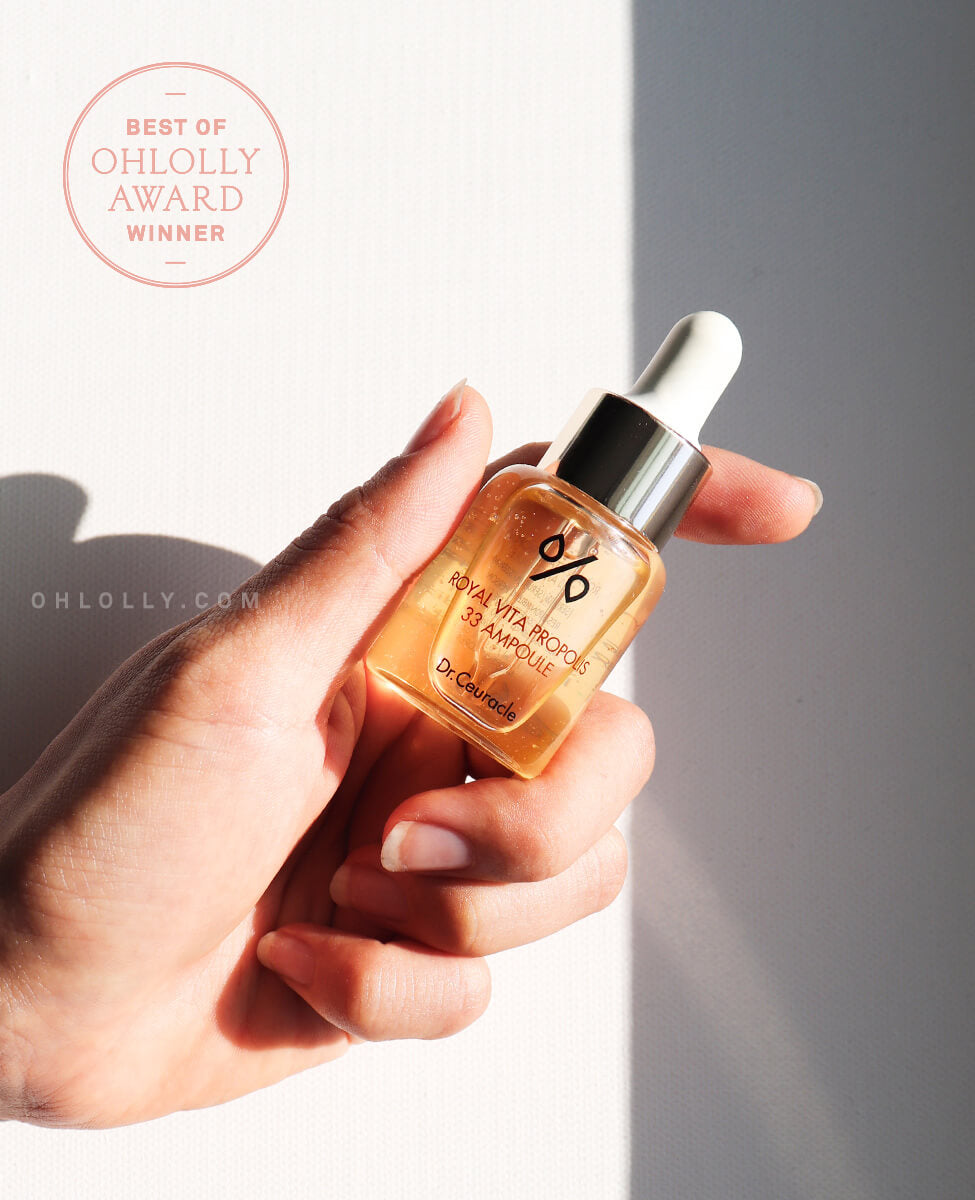 Hand holding Dr. Ceuracle Royal Vita Propolis 33 Ampoule, an award-winning K-beauty serum for glowing skin.
