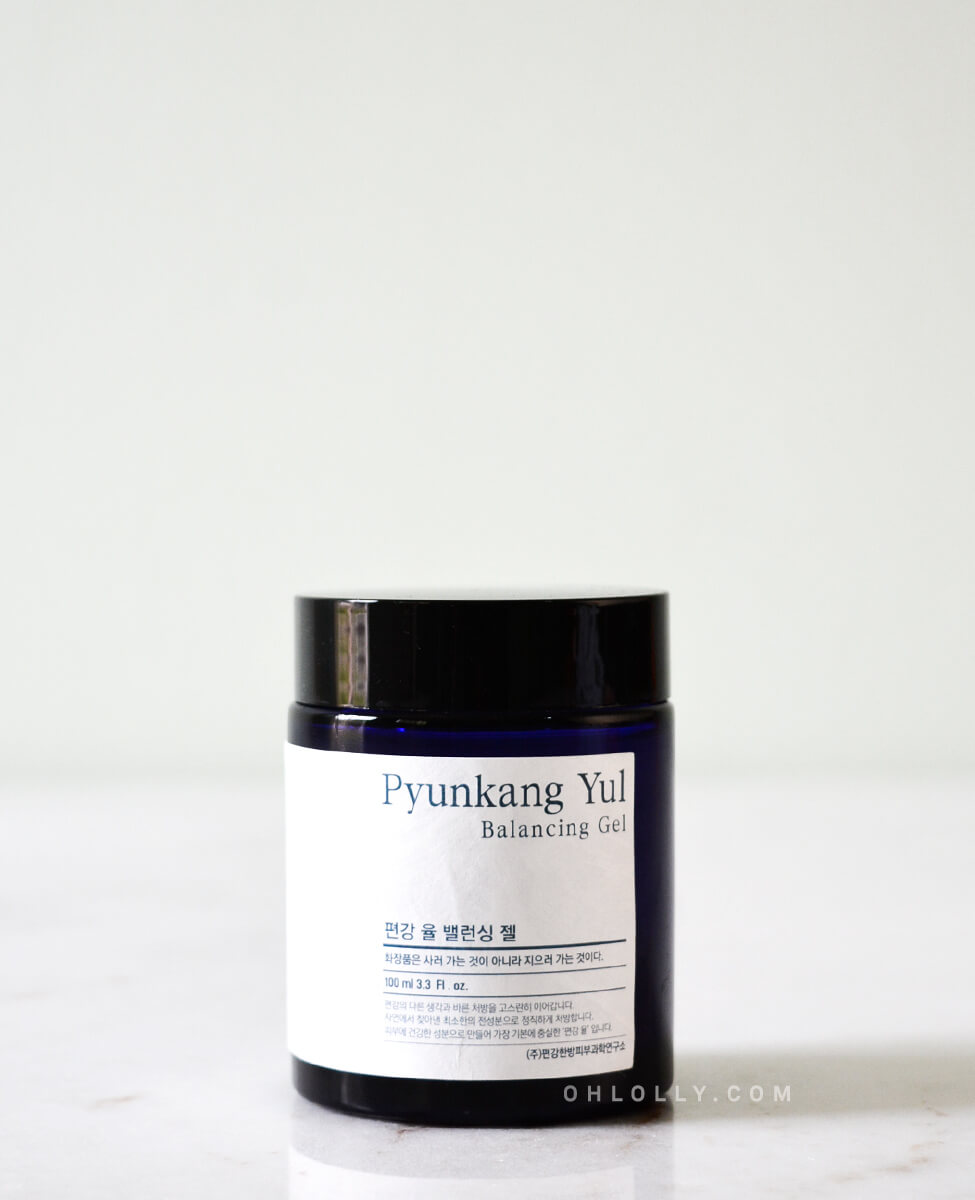 Close-up studio shot of the dark blue glass jar of Pyunkang Yul Balancing Gel, highlighting the white product label with the name and a small amount of text, emphasizing the brand's minimalist packaging.