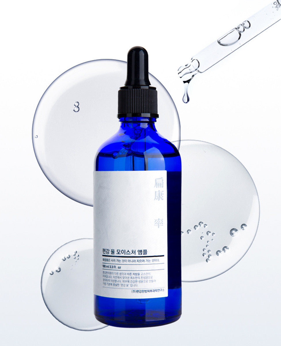 Close-up of the Pyunkang Yul Moisture Ampoule. The thick, viscous, honey-like gel is being slowly drawn up into the glass dropper, illustrating the product's unique texture.