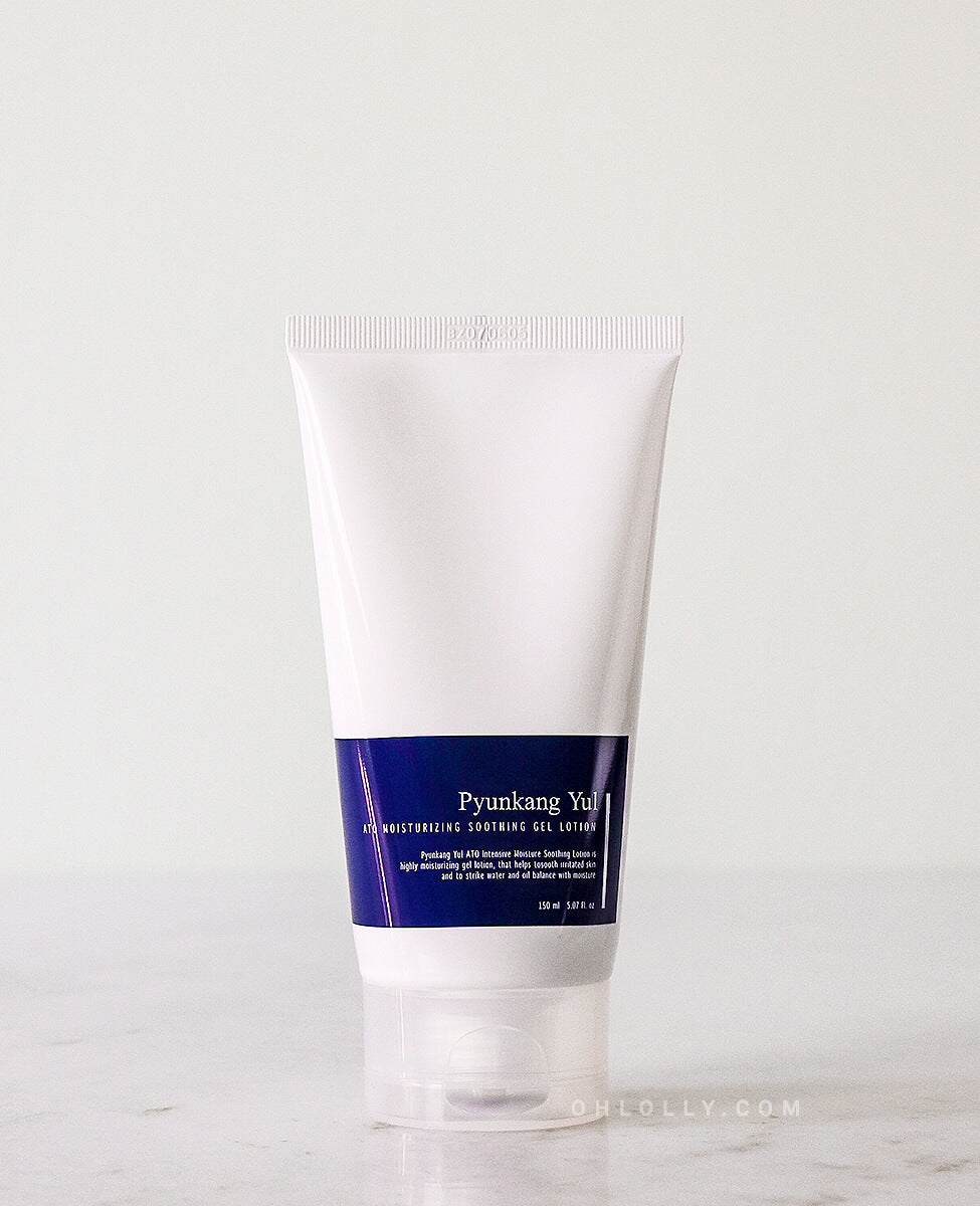 Front-on studio shot of the Pyunkang Yul ATO Moisturizing Soothing Gel Lotion tube, standing upright. The white tube with the dark blue label is centered on a pale background, emphasizing its minimalist design and the 'OHLOLLY.COM' branding at the base.