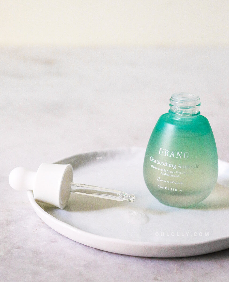 Urang Cica Soothing Ampoule bottle and dropper resting on a dish, highlighting the lightweight, fluid texture that soothes and strengthens delicate skin.