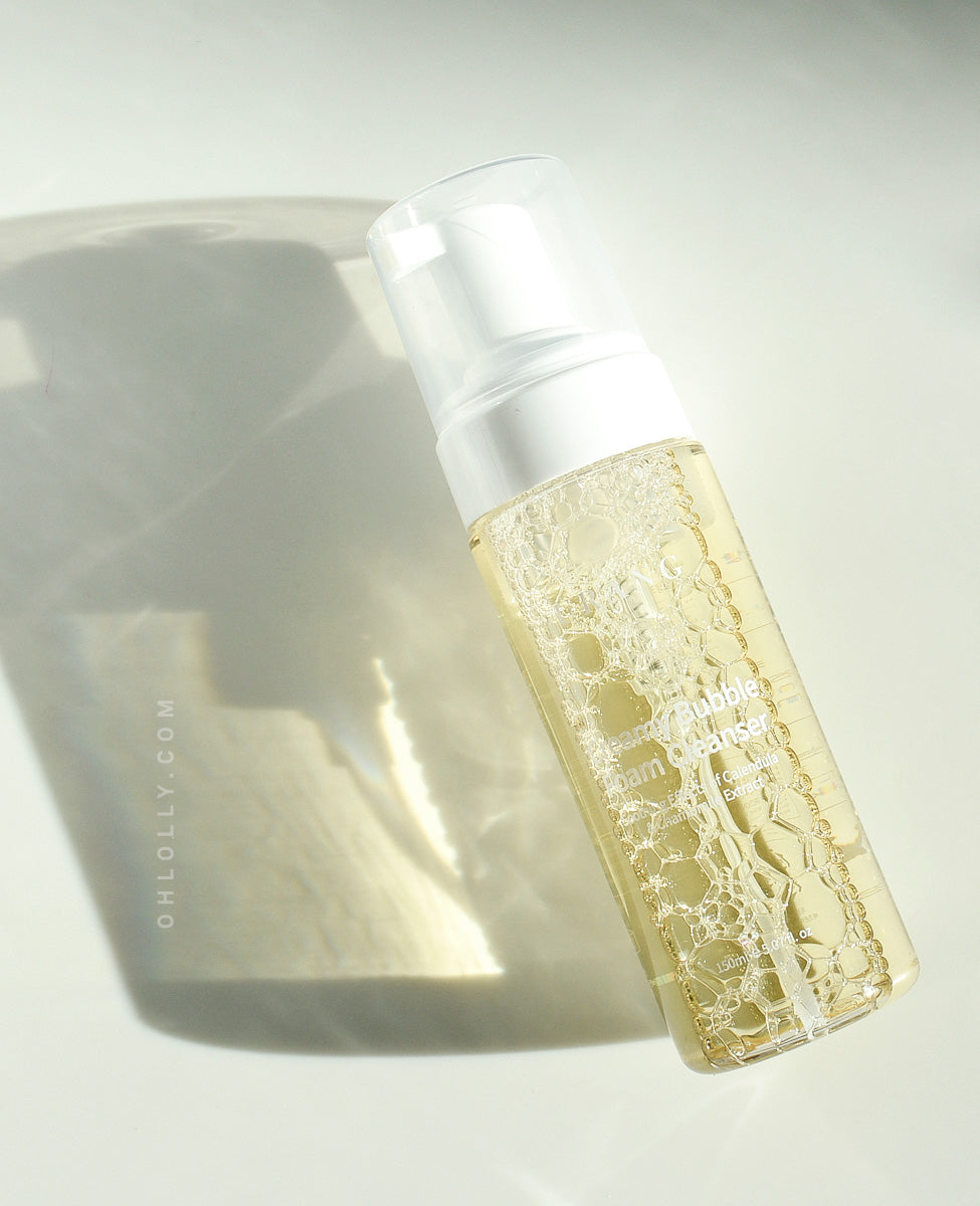 Close-up studio shot of the Urang Creamy Bubble Foam Cleanser bottle, emphasizing the calming benefits of its natural chamomile and calendula extracts for sensitive skin.