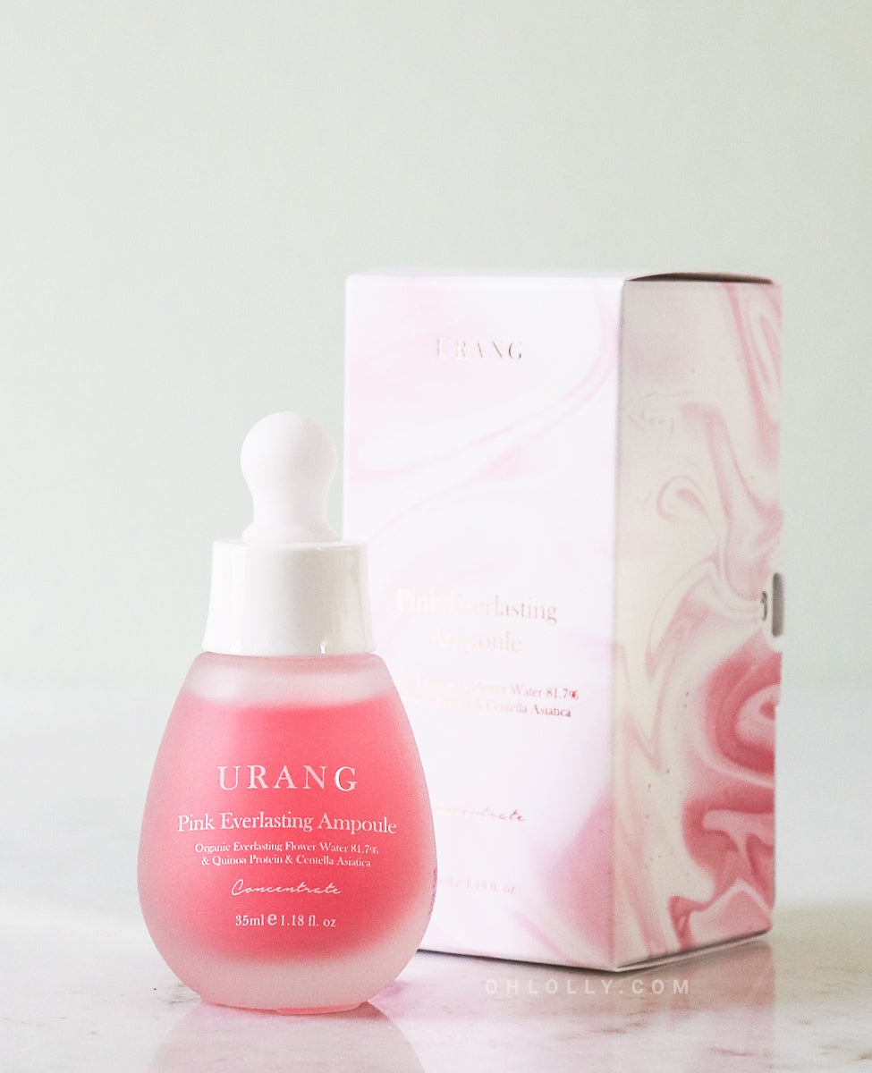 Urang Pink Everlasting AmpThe frosted pink glass dropper bottle of Urang Pink Everlasting Ampoule displayed next to its cardboard box with subtle pink rose illustrations, on a light background.