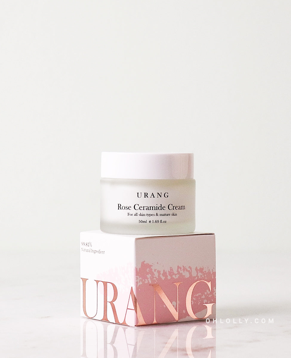 The Urang Rose Ceramide Cream: a wide, frosted glass jar with a white lid is placed on top of its matching minimalist, white and pink cardboard box packaging.