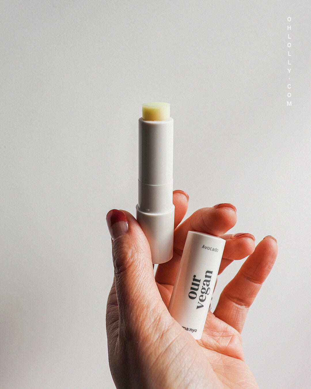 ma:nyo Our Vegan Color Lip Balm Green Pink_Hydrating, Color-matching Lip Balm, hand holding product in white background